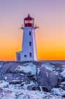 Peggys Cove Lighthouse in winter at sunset, Nova Scotia, Canada. Art Print